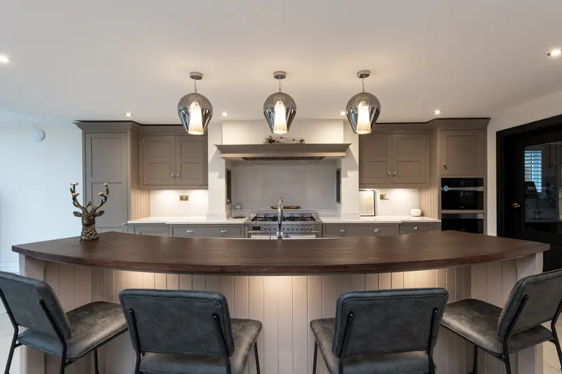 Kitchen island with pendant lights and bar stools