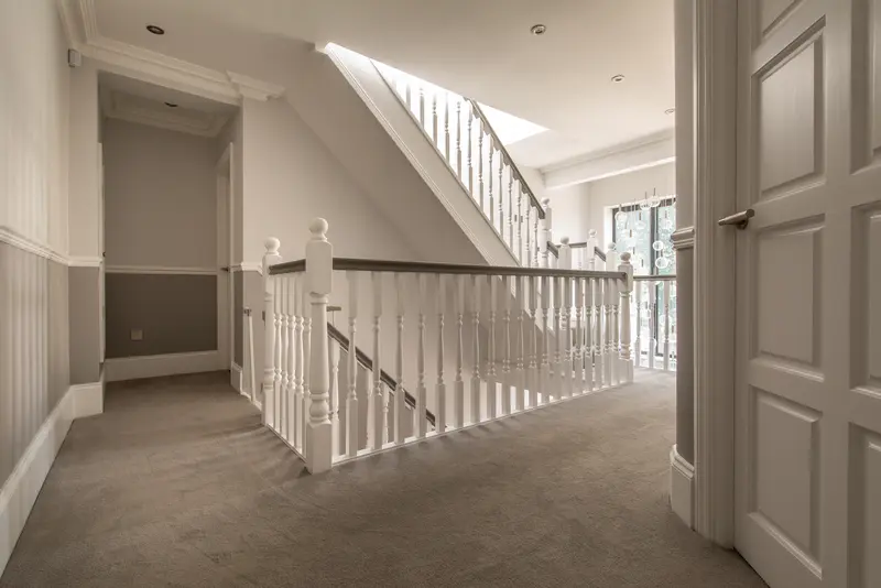 Bright first-floor landing with new staircase and panelled doors