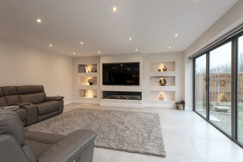 Living room with built-in media wall and large sliding doors